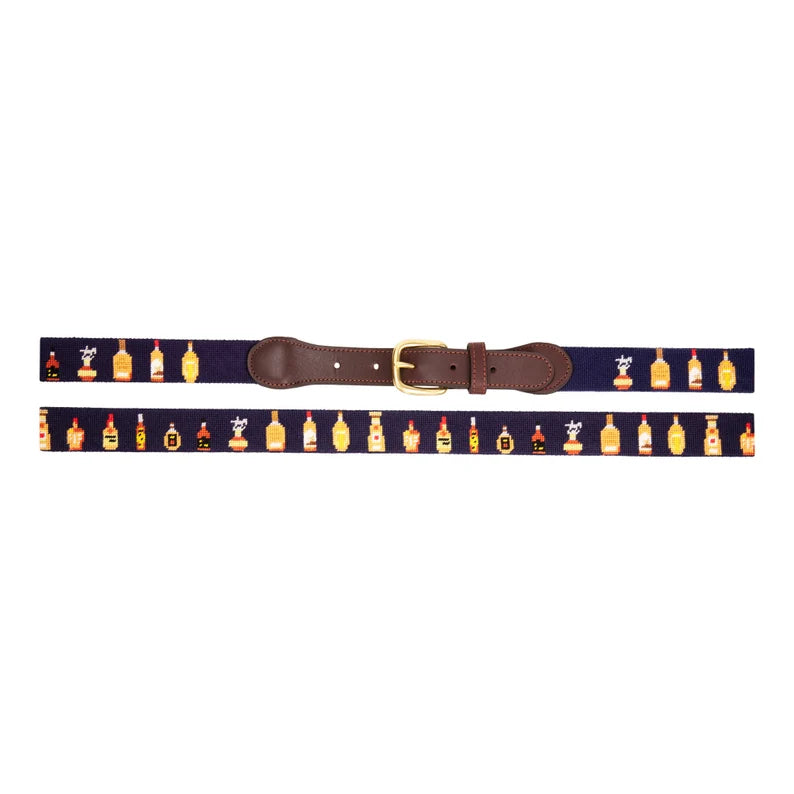 Whiskey bottles needlepoint belt laid flat showing full pattern with brass buckle and dark leather