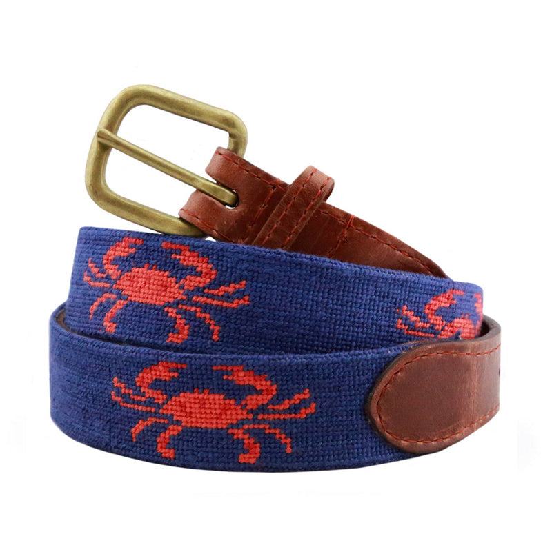 Navy blue red crab needlepoint belt flat lay and coiled view with brass buckle brown leather tab