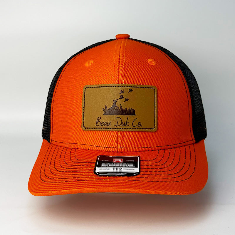Custom blaze orange black trucker hat interior underside view
