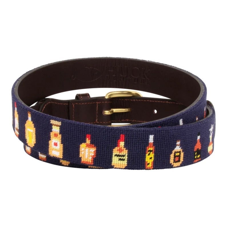 Navy blue whiskey bottles needlepoint belt coiled showing interior dark brown leather lining