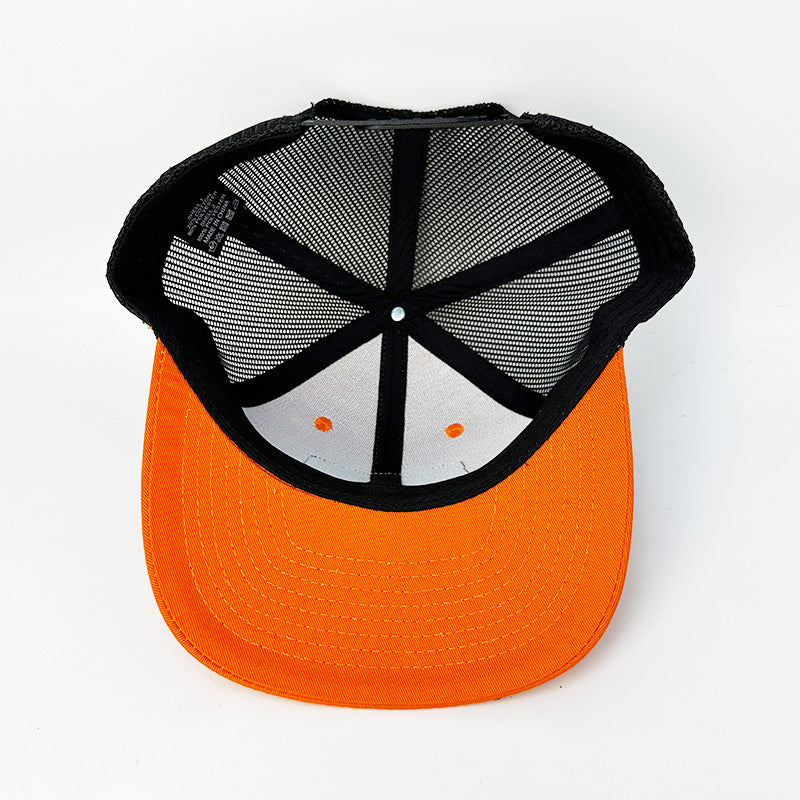 Custom blaze orange black trucker hat side profile view