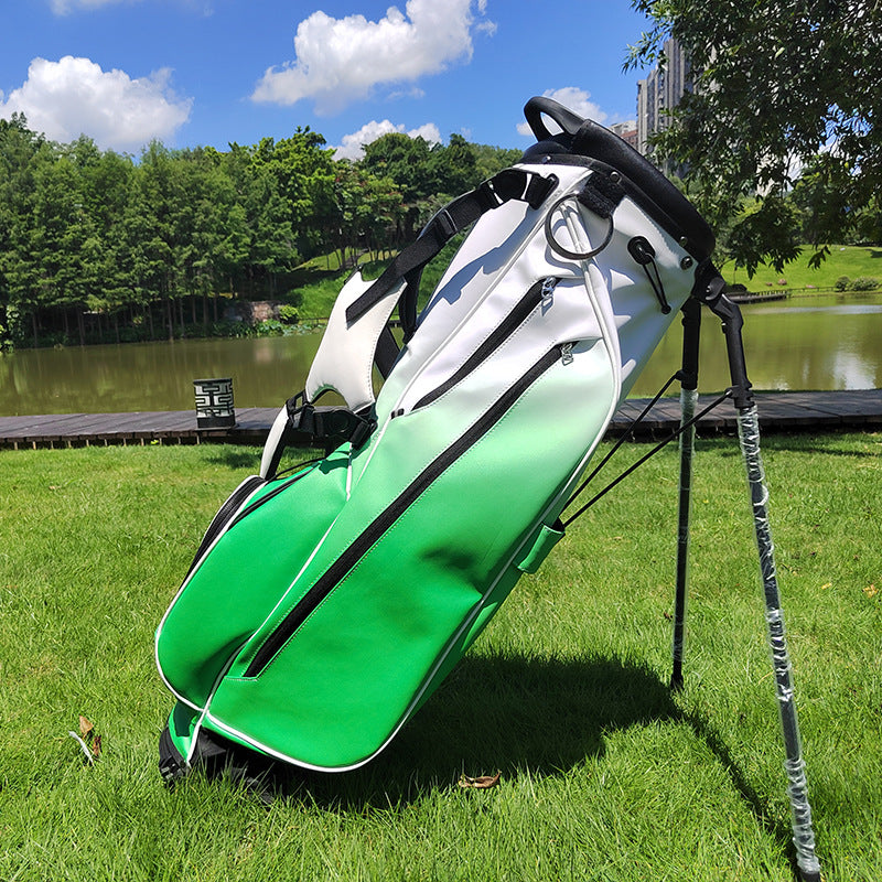 Gradient white green golf stand bag with dual leg stand deployed on fairway