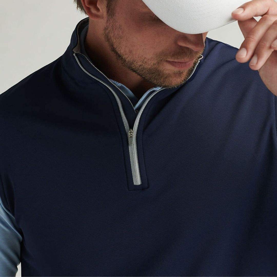 Navy quarter zip golf vest collar and zipper detail close-up