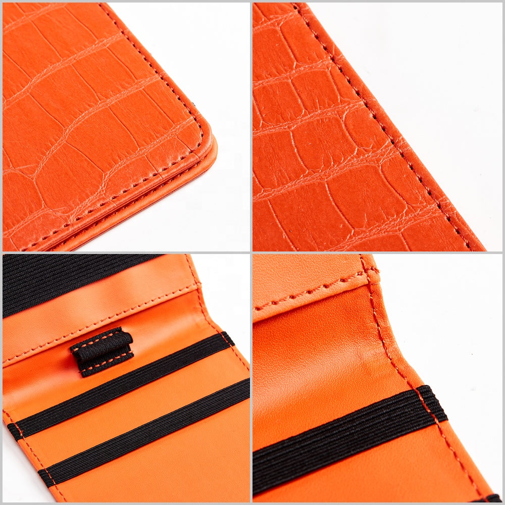 Orange crocodile leather scorecard holder detail showing elastic band stitching and interior