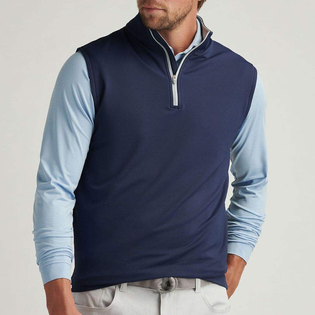 Navy quarter zip golf vest worn front view with polo underneath